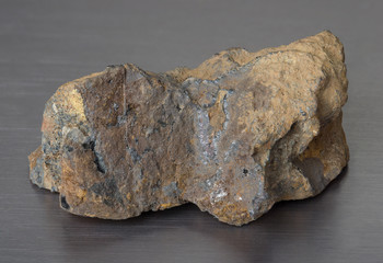 Specimen of iron ore mineral limonite (swamp ore) on gray background