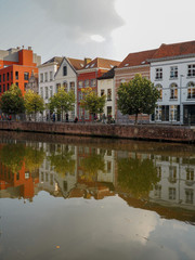 Obraz premium Historical houses reflected in the Dijle river at the old Haverwerf in the city center of Mechelen, Belgium