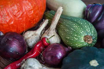 Autumn harvest of fruits and vegetables: pumpkin, eggplant, patisson, pepper, onion, garlic on wooden background