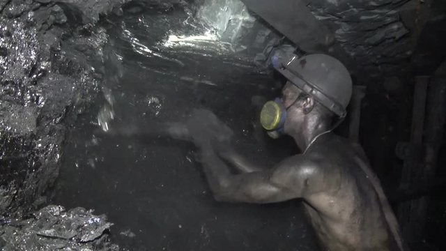 The man produces coal miner using a jackhammer
