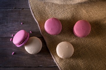 Macarons on burlap and wood surface