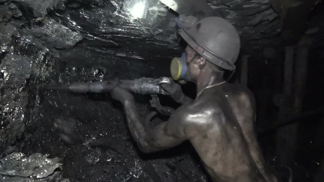 The man produces coal miner using a jackhammer