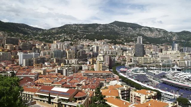 Left to right panoramic view of Monaco Monte Carlo in spring of 2018, water with yachts and luxury buildings. Real time medium shot