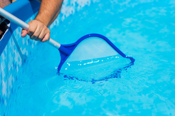 Backyard garden swimming pool cleaning close up