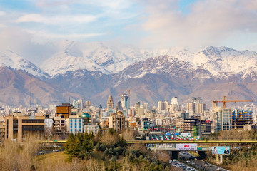 Islamic Republic of Iran. Tehran. City center and mountainous background. Freeway with Iran's flags. 02 March 2018 © Emily_M_Wilson