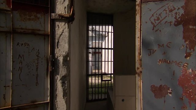 Abandoned prison door, trucking shot