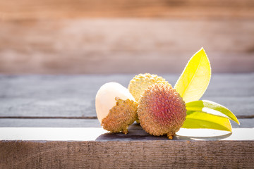 Lychee on wooden table under sunlight