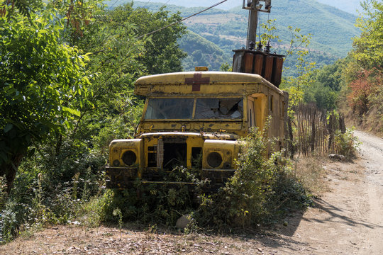 Old ambulance car decaying and corroding in the wilderness of Albania
