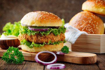 Fresh tasty chicken burger on wood table.