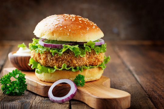 Fresh tasty chicken burger on wood table.