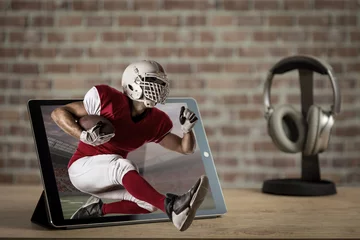 Tuinposter Football Player with a red uniform on a tablet. © beto_chagas