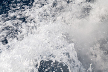 A view of the waves in the sea that are done behind the motorboat