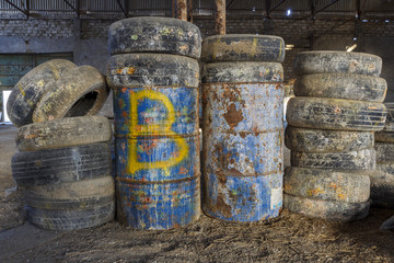 Old tires and barrels in an abandoned hangar
