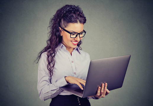happy business woman standing using laptop computer