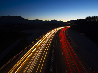 Car lights driven at speed by the highway