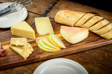 Delicious Meat and Cheese Board with Bread, Apple and Olives