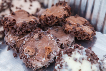 Closeup of Chocolate and Vanilla Ice Cream Discs with Nuts and Dark Chocolate Shavings