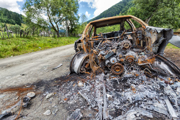 Fototapeta na wymiar Completely burned car on the country road