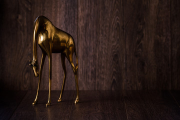Decorative Giraffe Brass Statuette on Brown Background