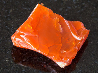 rough fire opal gem stone on black
