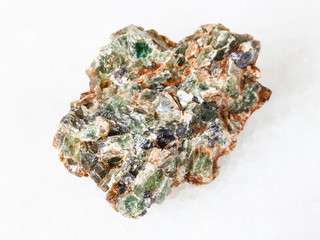 green beryl crystals in raw rock on white
