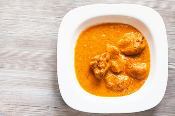 Murg Makhan Masala chicken pieces on wood board