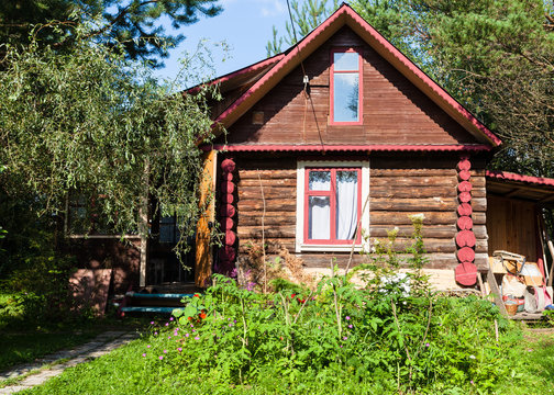 front view of rural log house on sunny summer day