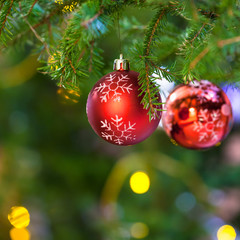 red balls with snowflake on fresh christmas tree