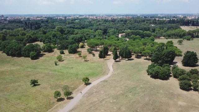 Aerial view Rome - A guy running in Pamphili Park at noon time under summer sun