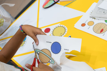 prints of colored planets to cut out and glue on a red ribbon. Educational activity for children on...