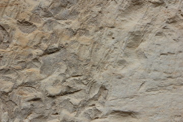 Texture of an old wall. Surface of an ancient temple in Prague. Background of stone for the designer. Pattern in brown tones