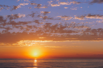 Sunrise in the waves of the sea. Sunset on the sea.