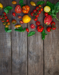  fresh organic colorful tomatoes on wooden surface