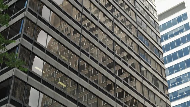 Tilt Down and Pan of Modern Business Office Buildings with Glass Reflection. 4K