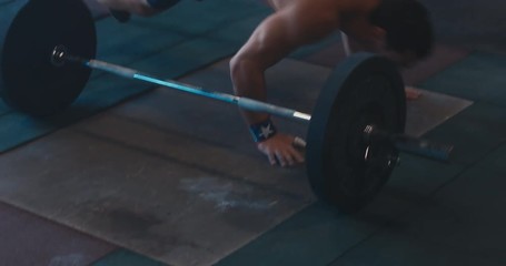 HANDHELD portrait of Caucasian male athlete doing high intensity workout in a functional gym. 4K UHD
