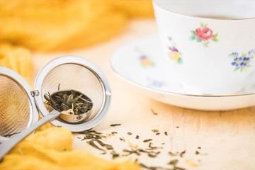 Crown Staffordshire Fine Bone China Loose Leaf Green Tea in Spoon and Diffuser on Yellow Background