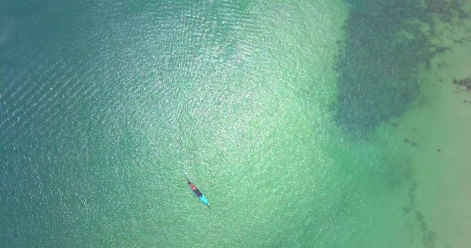 
Aerial: Sea surface view with sun reflection and single boat at center,static video