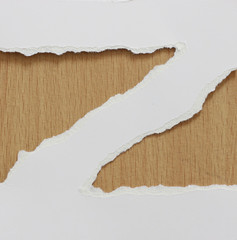 torn white paper texture on wood background, copy space. © naiauss