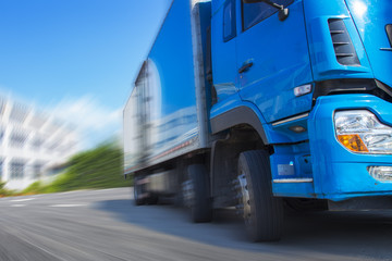 Fototapeta premium a blue truck galloping on the road