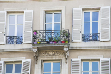 Fototapeta na wymiar Close up of decorative, metal, window balcony with colorful flower pots 