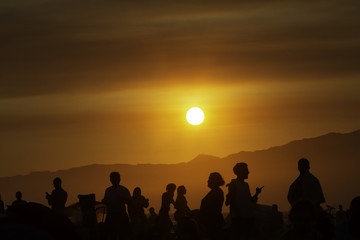 Fototapeta na wymiar People watching sunset over Santa Monica in California