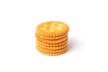 Round salted cracker cookies stacked isolated on white background.