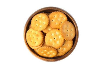 Round salted cracker cookies in wooden bowl isolated on white background.
