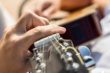 Close up of the left hand of a guitarist playing chords.