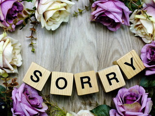 sorry word wooden block with artificial roses flowers decor