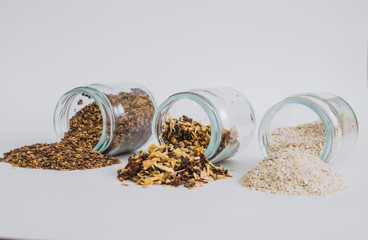 Glass jars with various grains, oats, linseed, dry seasoning