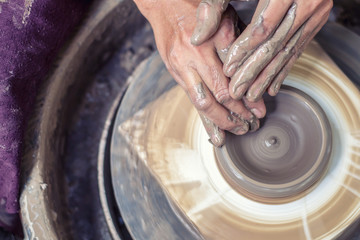 Hands working on pottery wheel