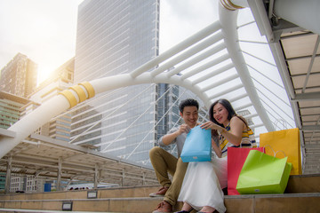 Happy couple doing shopping in town