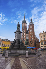 Fototapeta na wymiar St Mary's Basilica (Mariacki Church) and Adam Mickiewicz Monument on The Main Market Square in the Old Town of Krakow (Cracow)