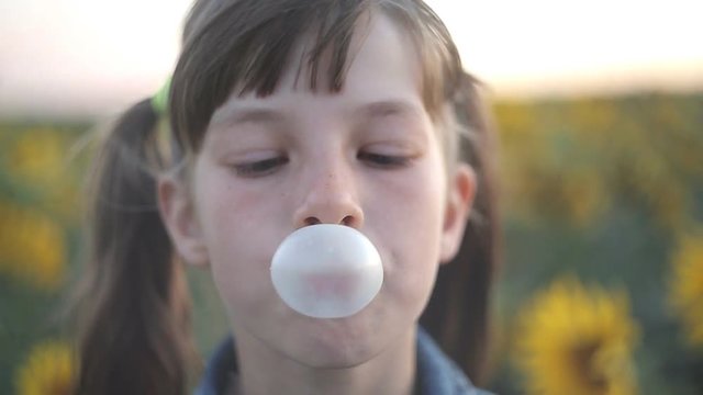 Beautiful teen girl inflating bubble of chewing gum. Moderm fashion girl.